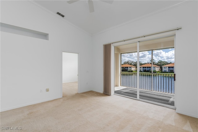 spare room featuring a water view, light carpet, crown molding, and ceiling fan