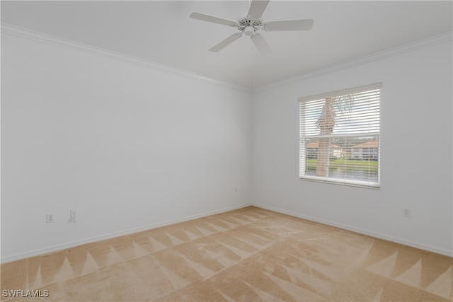 carpeted empty room featuring ceiling fan and crown molding