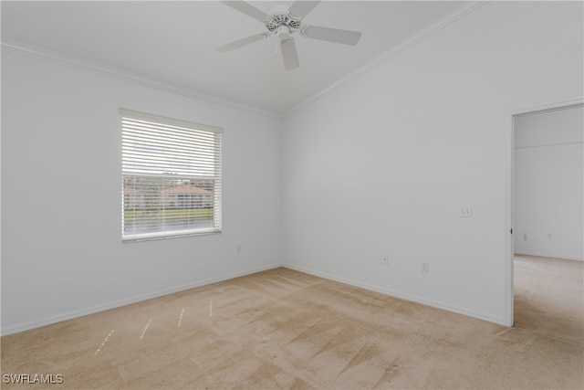 carpeted spare room with lofted ceiling, ceiling fan, and crown molding