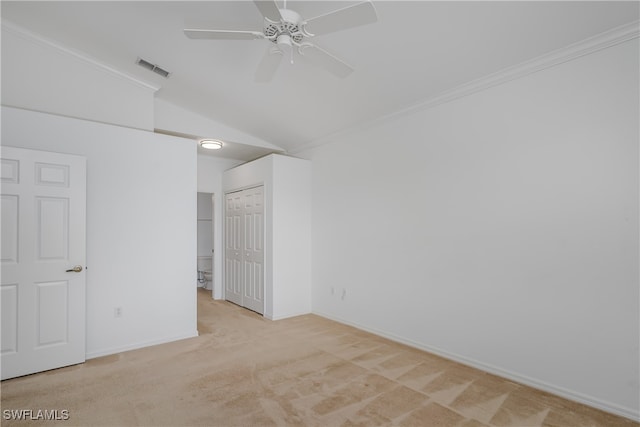 carpeted spare room with ceiling fan, crown molding, and lofted ceiling