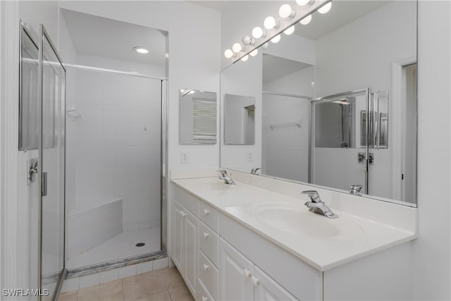 bathroom with vanity, an enclosed shower, and tile patterned flooring