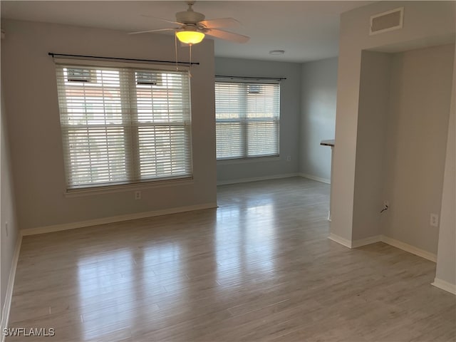 unfurnished room with ceiling fan and light hardwood / wood-style flooring