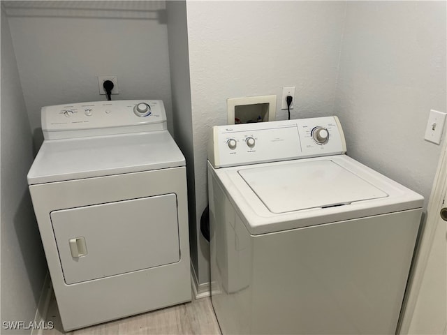 washroom featuring washer and dryer and light hardwood / wood-style flooring