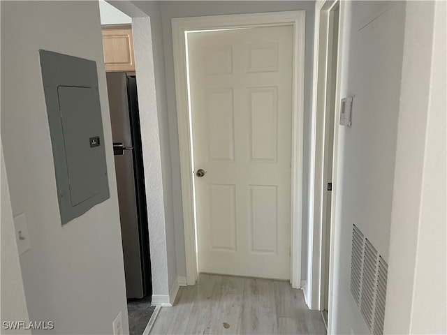 hallway featuring electric panel and light wood-type flooring