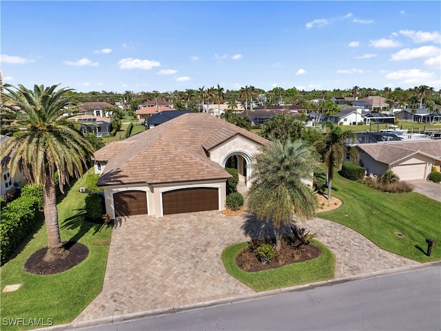 view of front of home with a front lawn and a garage