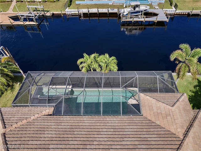 dock area featuring glass enclosure and a water view