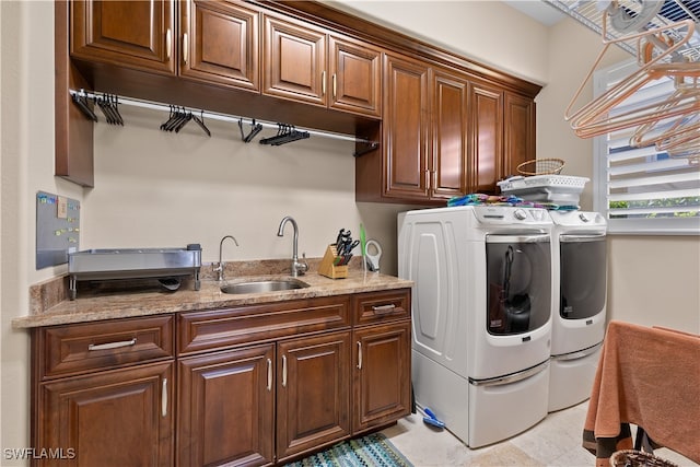 washroom featuring washer and clothes dryer, cabinets, and sink