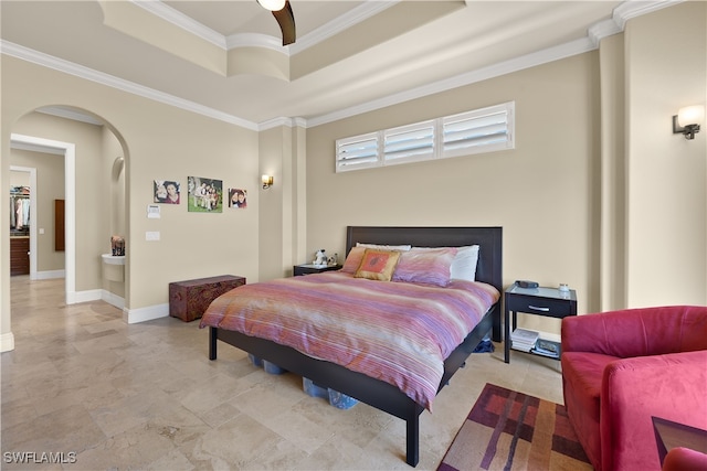 bedroom featuring a tray ceiling, crown molding, and ceiling fan