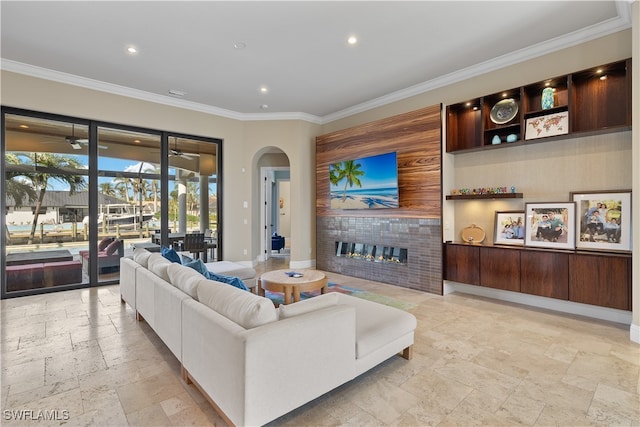 living room featuring a fireplace and crown molding