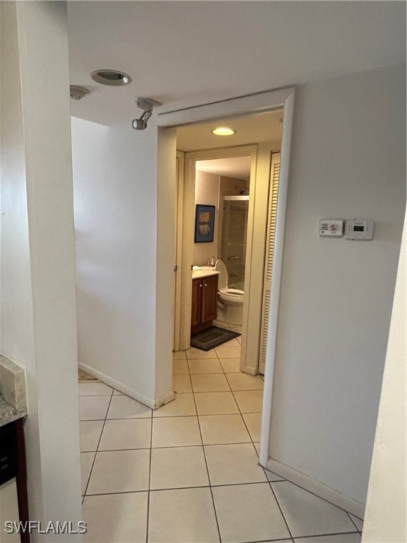 corridor featuring light tile patterned flooring