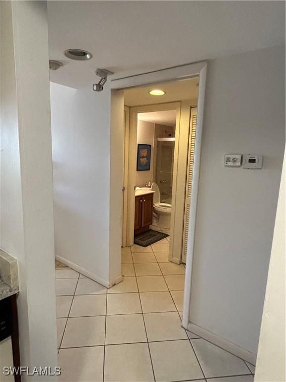 4510 N Key Dr Unit 105, North Fort Myers, FL 33903 - hallway with light tile patterned floors and baseboards