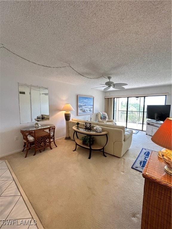 living room with carpet floors, a textured ceiling, and ceiling fan