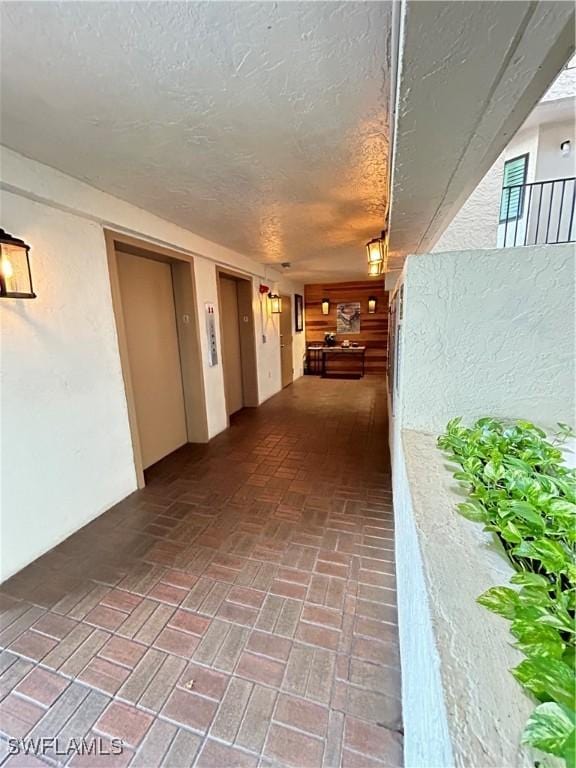 4510 N Key Dr Unit 105, North Fort Myers, FL 33903 - hallway featuring brick patterned floors and a textured ceiling