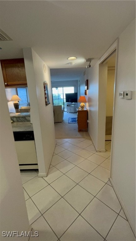 hallway featuring light tile patterned floors