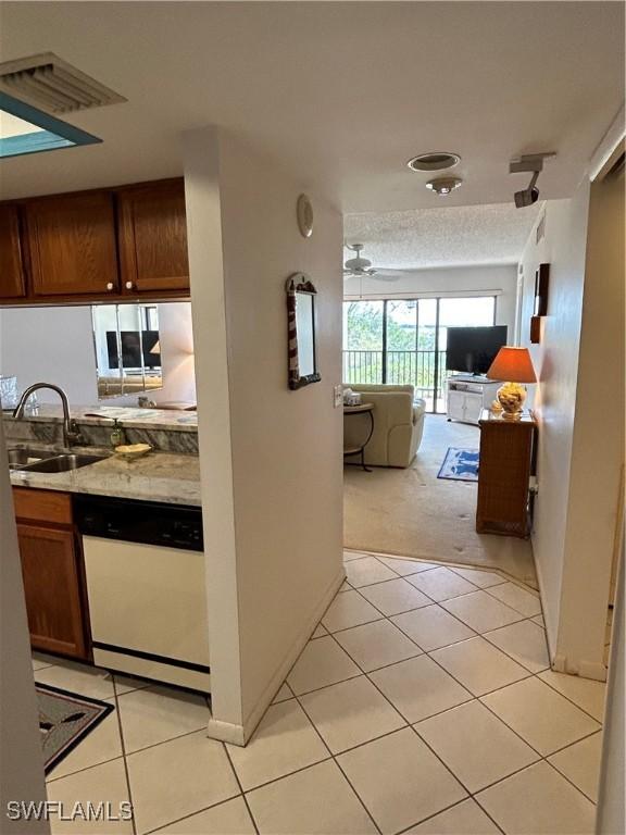 4510 N Key Dr Unit 105, North Fort Myers, FL 33903 - corridor featuring a sink, light tile patterned floors, and light colored carpet