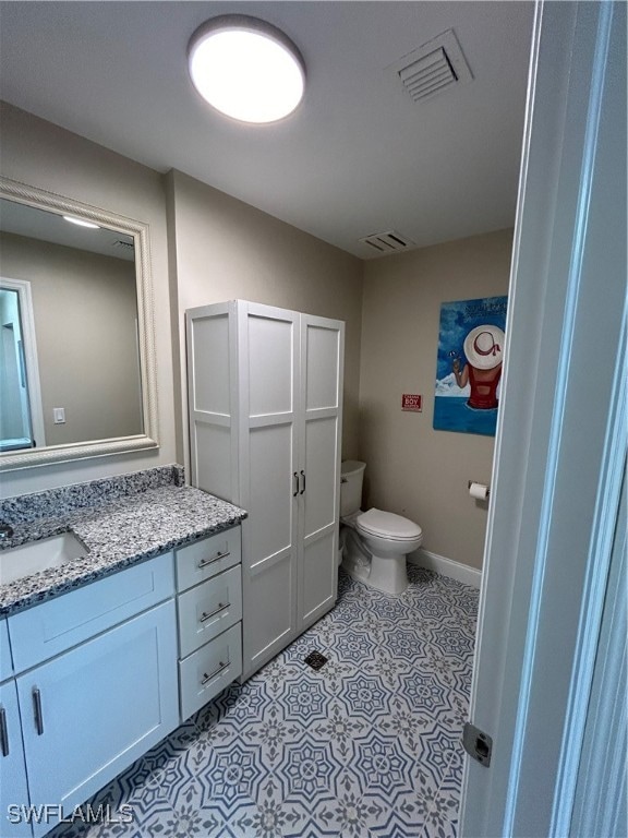 bathroom featuring vanity and toilet