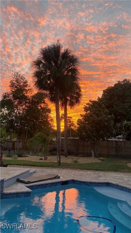 pool at dusk with a yard