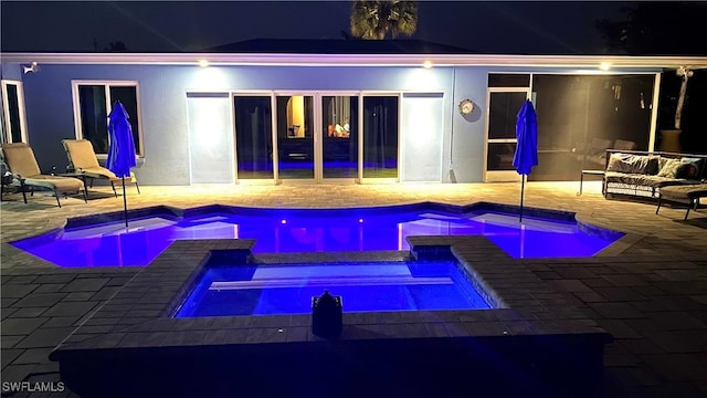 1857 Whitecap Cir, North Fort Myers, FL 33903 - pool at twilight featuring a patio and a pool with connected hot tub
