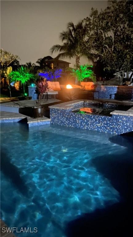 1857 Whitecap Cir, North Fort Myers, FL 33903 - pool at twilight featuring an outdoor pool and a jacuzzi
