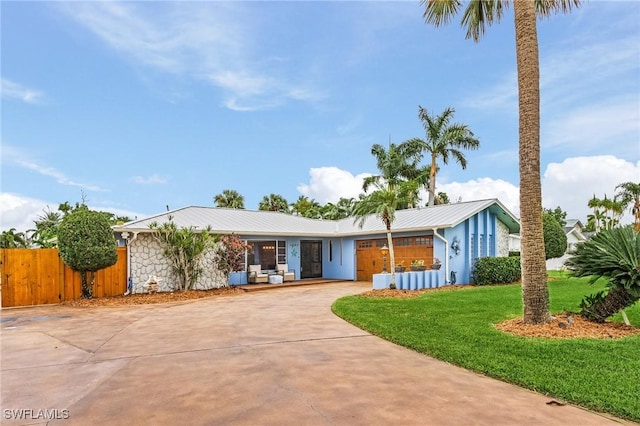 1857 Whitecap Cir, North Fort Myers, FL 33903 - ranch-style house with driveway, metal roof, and stone siding