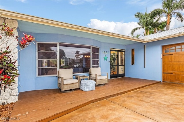 1857 Whitecap Cir, North Fort Myers, FL 33903 - doorway to property featuring stucco siding, a wooden deck, metal roof, and a standing seam roof