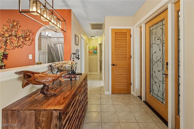 1857 Whitecap Cir, North Fort Myers, FL 33903 - foyer entrance featuring light tile patterned flooring, arched walkways, and baseboards