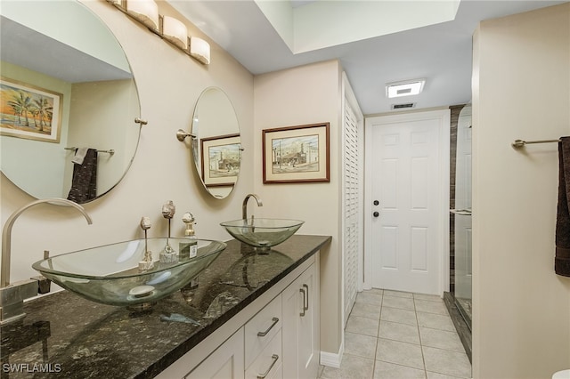 bathroom with vanity, tile patterned flooring, and a shower with shower door