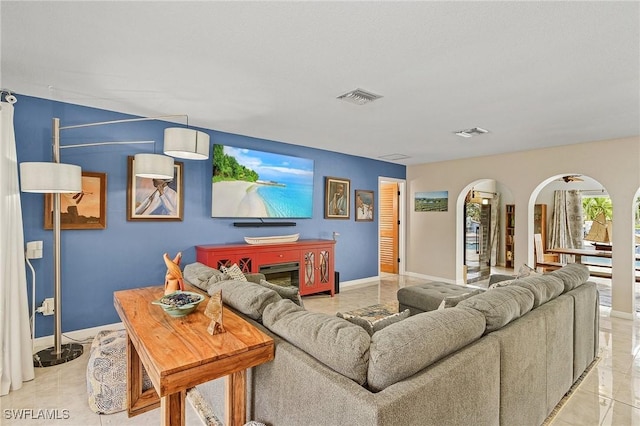 1857 Whitecap Cir, North Fort Myers, FL 33903 - living room featuring arched walkways and baseboards