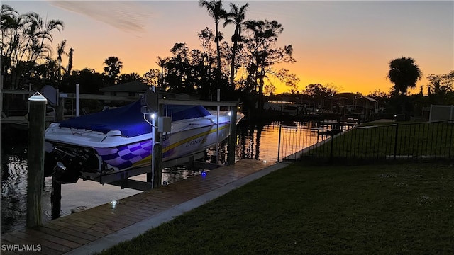 dock area featuring a water view and a yard