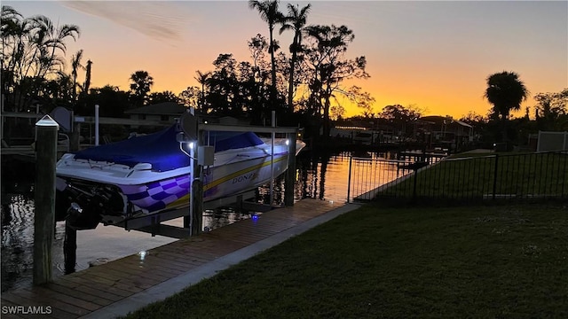 1857 Whitecap Cir, North Fort Myers, FL 33903 - dock with boat lift, a water view, and a lawn