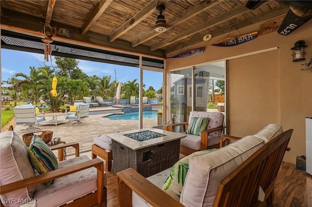 view of patio featuring a fire pit and ceiling fan