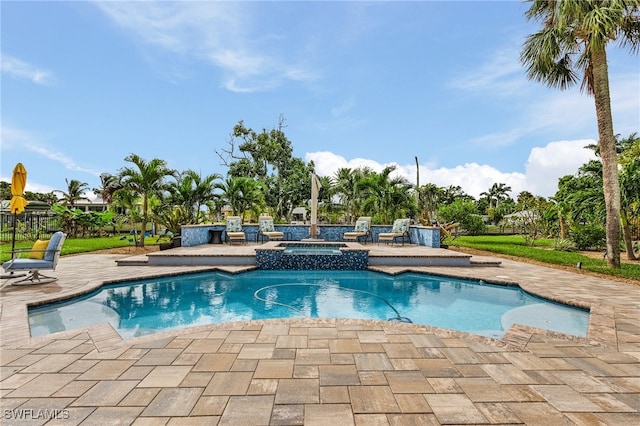 view of swimming pool featuring an in ground hot tub and a patio area