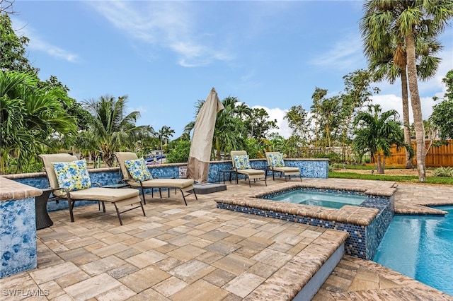 view of swimming pool with a patio and an in ground hot tub