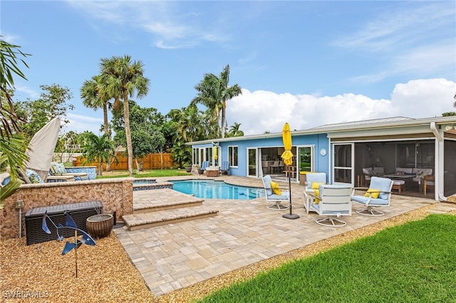 view of pool featuring a sunroom and a patio area