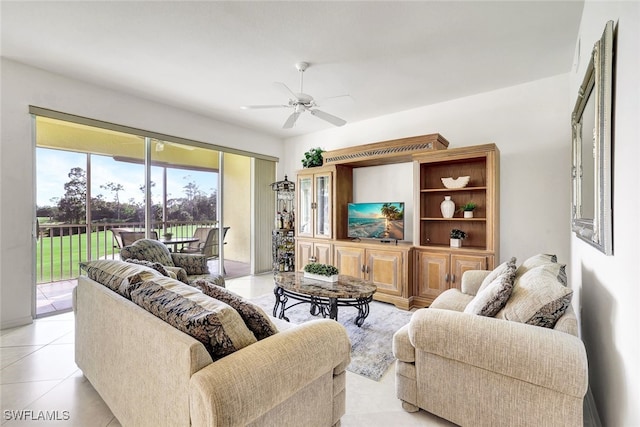 tiled living room with ceiling fan