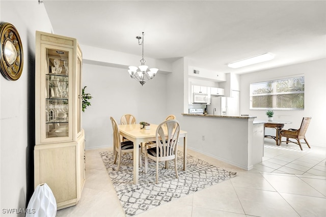 dining area with a notable chandelier and light tile patterned floors