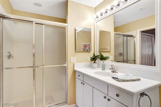 bathroom with an enclosed shower and vanity