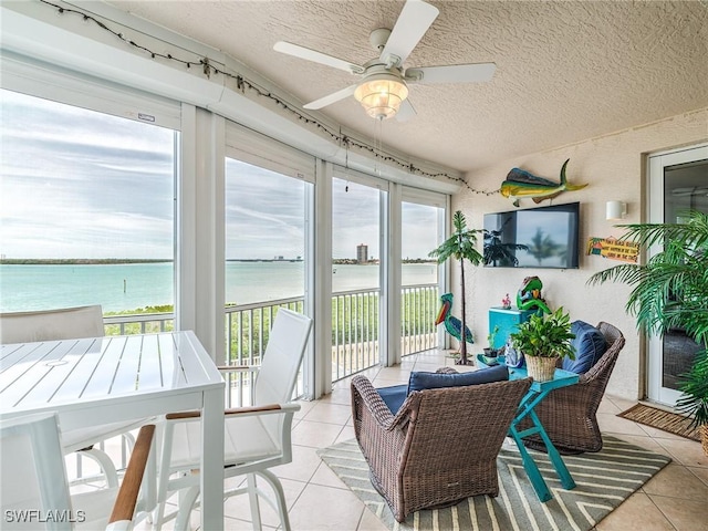 sunroom featuring ceiling fan