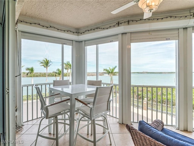 4137 Bay Beach Ln Unit 532, Fort Myers Beach, FL 33931 - sunroom with a water view, plenty of natural light, tile patterned flooring, and a textured ceiling