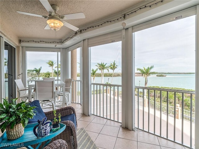 4137 Bay Beach Ln Unit 532, Fort Myers Beach, FL 33931 - sunroom with a water view, a textured ceiling, and tile patterned floors