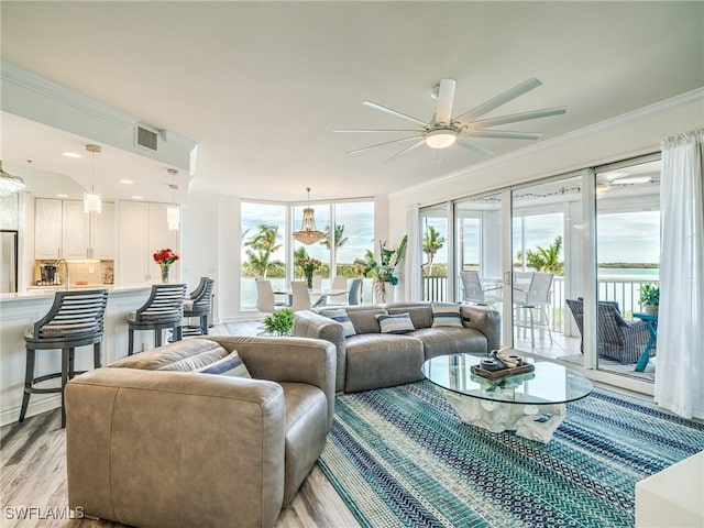 4137 Bay Beach Ln Unit 532, Fort Myers Beach, FL 33931 - living area featuring ceiling fan, ornamental molding, light wood-type flooring, and healthy amount of natural light