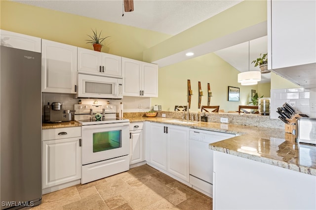 kitchen with kitchen peninsula, light stone counters, white appliances, white cabinets, and hanging light fixtures