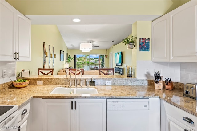 kitchen featuring white cabinetry, sink, light stone countertops, white appliances, and decorative backsplash