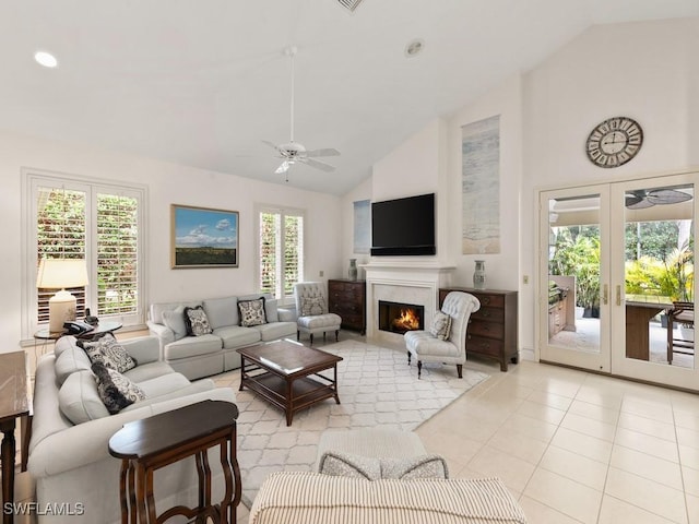 living room with french doors, light tile patterned floors, high vaulted ceiling, and ceiling fan