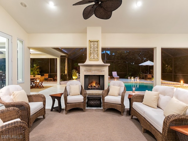 view of patio featuring an outdoor living space with a fireplace and ceiling fan