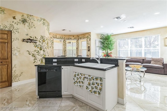 kitchen with sink, dishwasher, white cabinetry, dark stone countertops, and hanging light fixtures