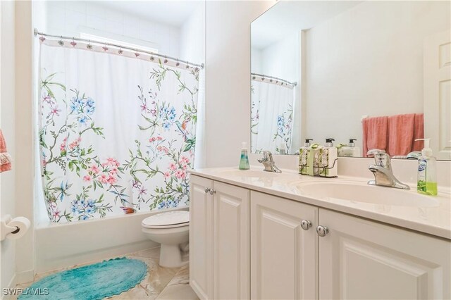 full bathroom with shower / bath combo with shower curtain, vanity, and toilet