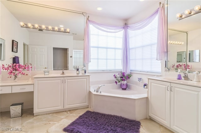 bathroom with vanity, a bath, and a wealth of natural light