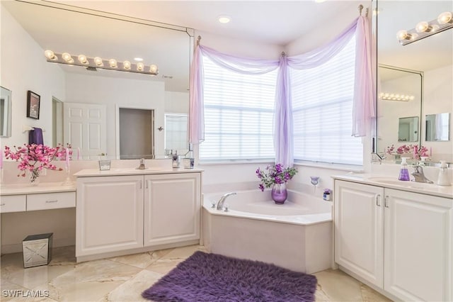 bathroom featuring vanity and a tub