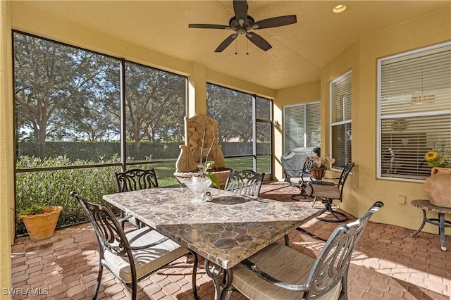 sunroom / solarium featuring ceiling fan